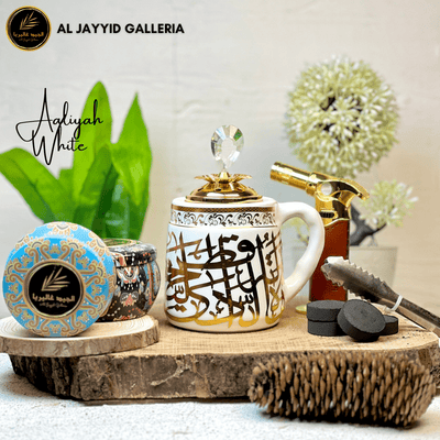 Aaliyah 'عاليه' Bakhoor Burner (White) placed on wooden surface with bakhoors.